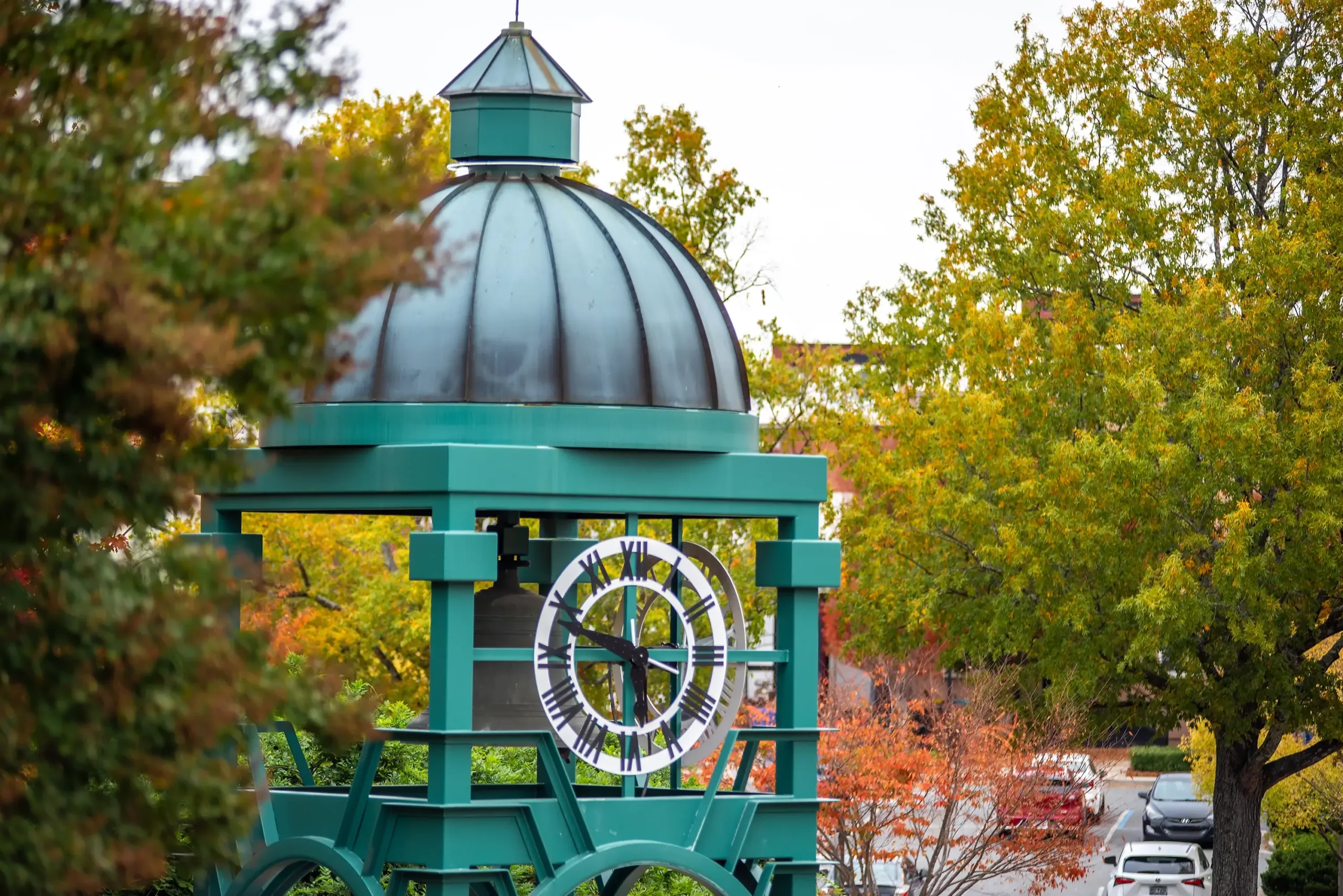 A green colored clock tower