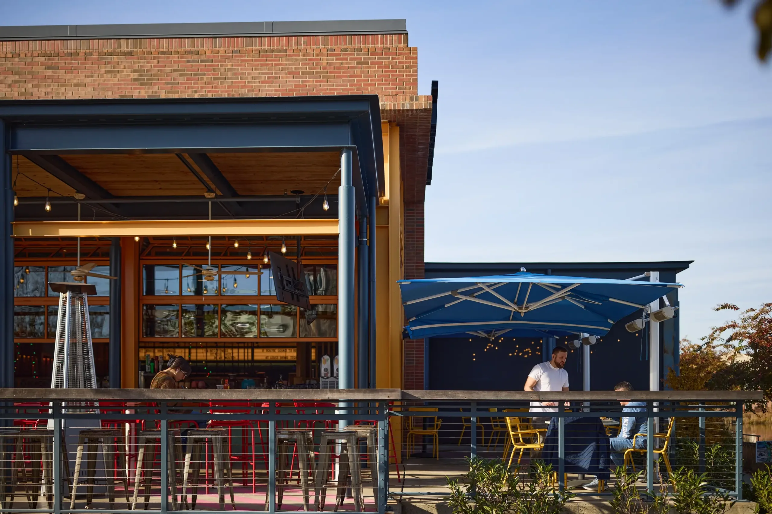 People eating on the patio of a restaurant